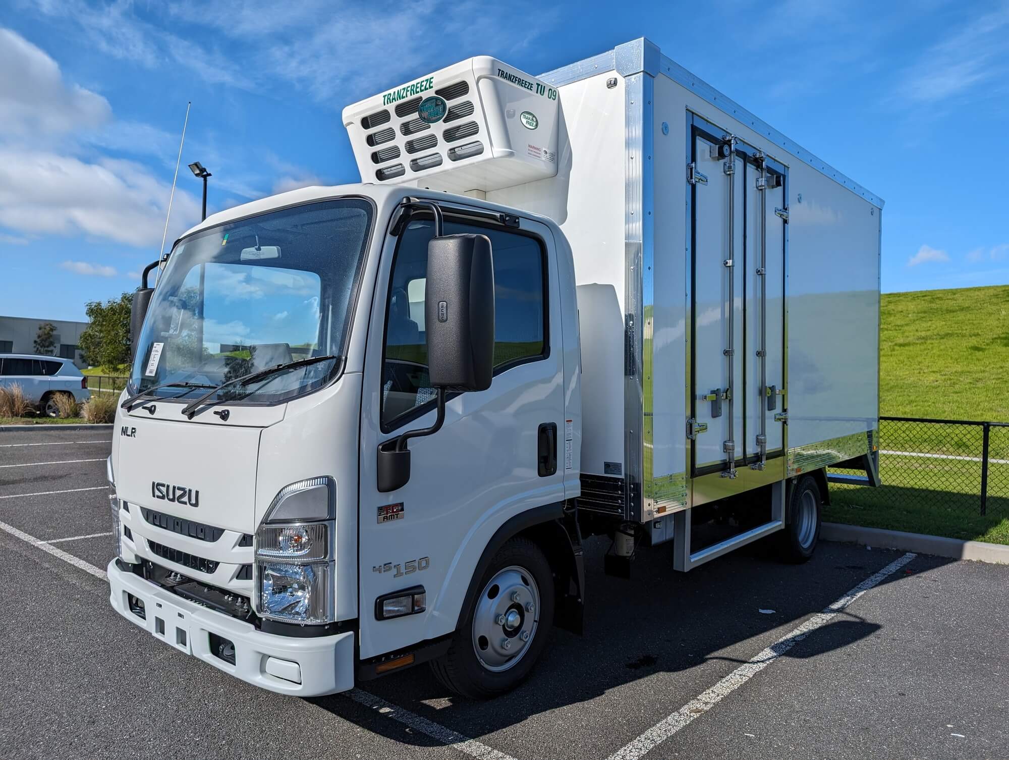 Isuzu NLR refrigerated truck body, side view