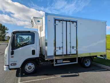 Isuzu NLR refrigerated truck with the side door open
