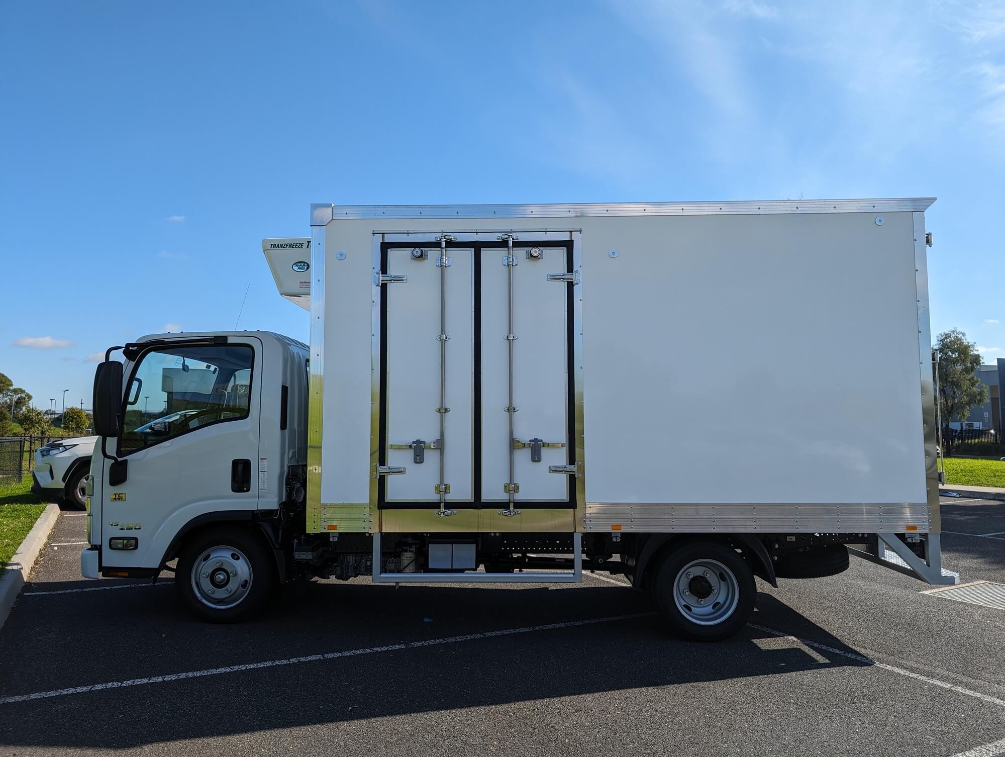 Isuzu refrigerated truck body viewed from the kerb side