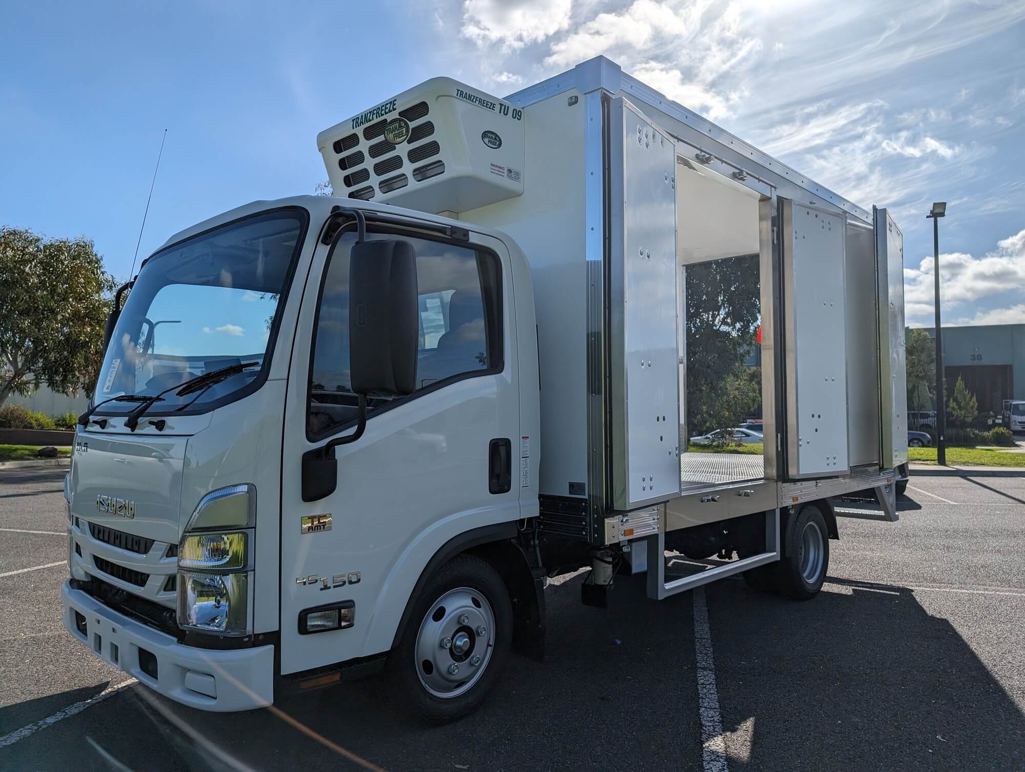 Isuzu refrigerated truck with a Tranzfreeze body, side view