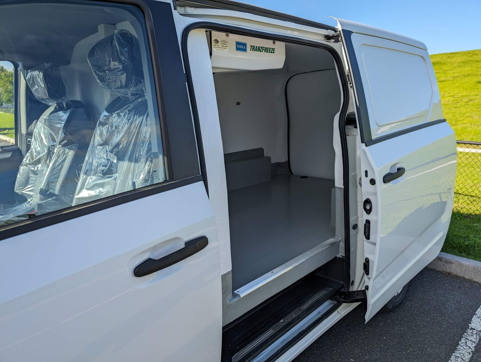Refrigerated van with the side door open beside the driver's seat