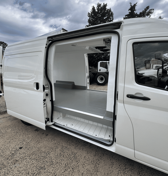 Refrigerated van with the side door open showing insulated lining and flat floor