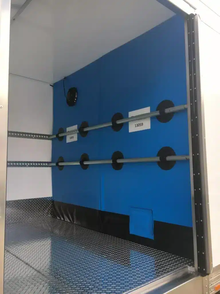 Blue divider wall inside a refrigerated truck body
