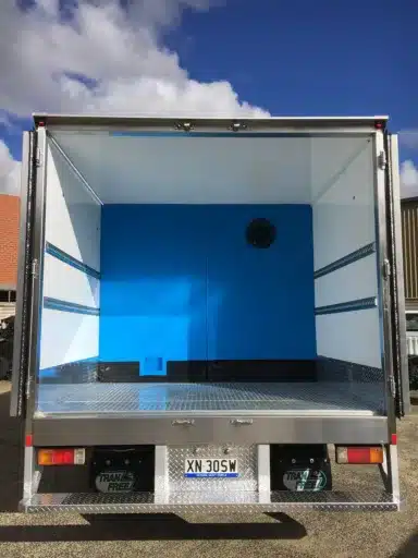 Refrigerated truck body with the rear doors open showing the divider