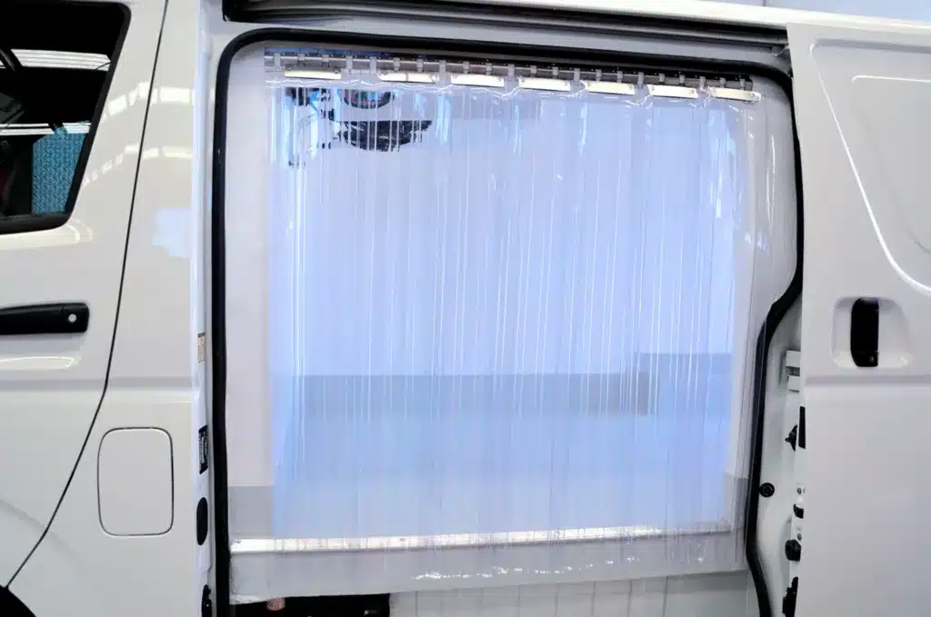 Plastic strip curtains fitted at the side door of a refrigerated van